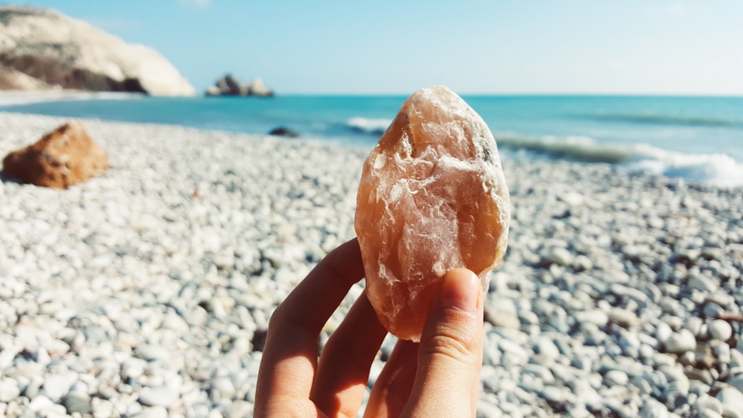 A high-resolution image of raw Himalayan salt boulders being hand-sorted by experts, highlighting the natural crystalline structure and varying shades of pink